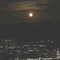 写真: 街並みに月