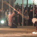 写真: 狐のお面を被った人が石動の周りを踊りながら一周、「祝祭」が始まります